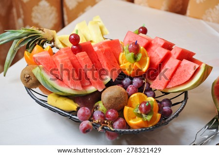 Carved fruits arrangement. Fresh various fruits. Assortment of exotic fruits. Fresh fruits decoration