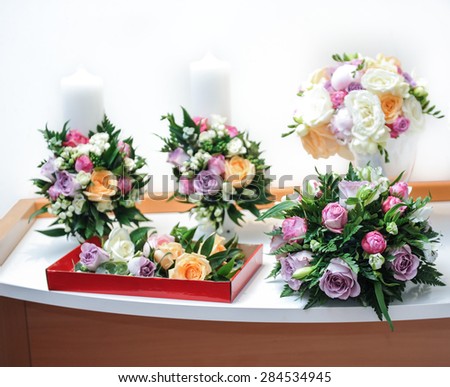 Beautiful bouquets of rose flowers, on table. Wedding bouquets of different colors roses. Elegant wedding bouquets on table at restaurant