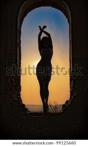 silhouette of a young  sensual woman in the window