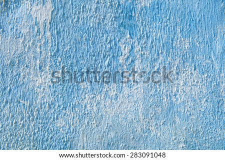 Blue scratched painted texture background frame on concrete wall. For backdrops and wallpaper. Pattern of rustic blue grunge material. Close up.