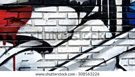 Brick spray painting wall colorful background. Abstract rustic and grunge texture urban. Many spray paint colors. For young street magazine background. Close up.