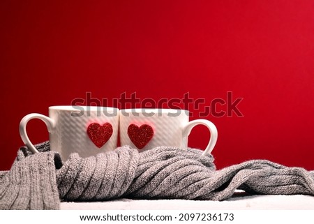 Photo of Cups full of love. Pleasure, inspiration, feelings contained in one word, which is love. A hot heart in a tender embrace. Perfect texture for a greeting card for a loved one.