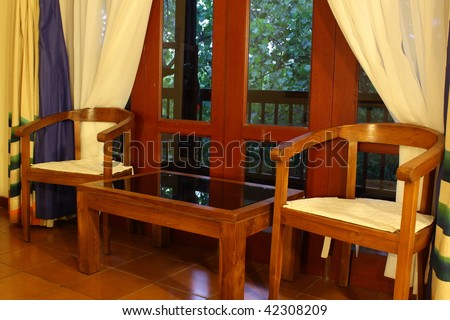 Old-fashioned interior with wood furniture (room in tropical hotel)