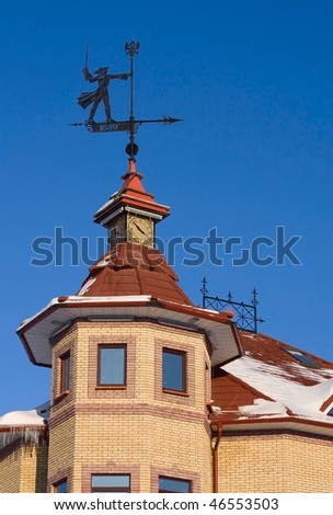Weathercock man on a roof top