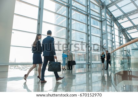 Business people walking in modern glass office building Stock foto © 