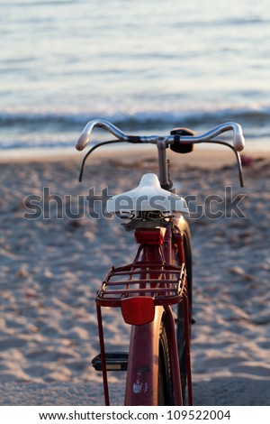 Old red bike on the beach