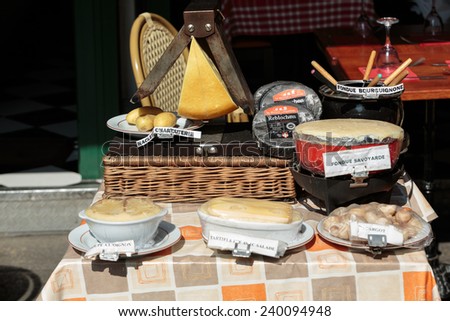 Paris, France - September 8, 2014: Latin Quarter of Paris, France. Splendid French cheeses tempt with the smell before the entry to the restaurant