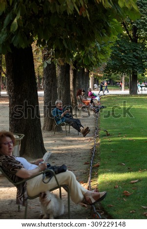 PARIS, FRANCE - SEPTEMBER 8, 2014: People relax in Luxembourg Gardens in Paris, France. Luxembourg area is popular among tourists in Paris, the most visited city worldwide.