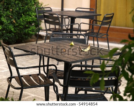 empty tables in cafes in the rain