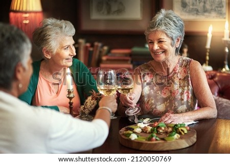 Lets drink to a lifetime of happiness. Cropped shot of a group of senior female friends enjoying a lunch date. ストックフォト © 