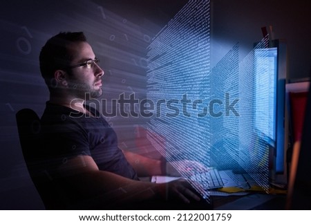 He's embedded in the code. Cropped shot of a young computer programmer looking through data. Stockfoto © 