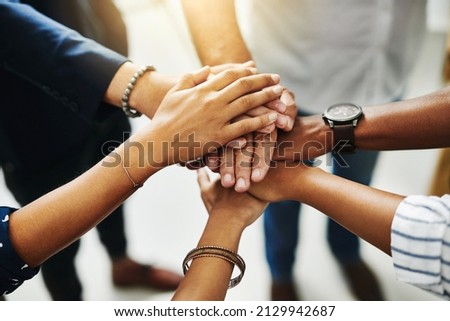 Together, anything is possible. Closeup shot of a group of unrecognizable businesspeople joining their hands together in a huddle. Photo stock © 
