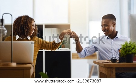 Bring it in partner. Shot of two young work colleagues greeting each other with a fist pump while being seated in the office. ストックフォト © 
