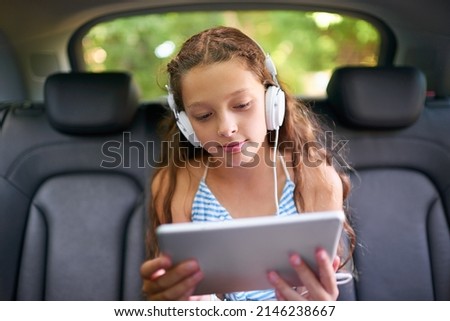 Similar – Image, Stock Photo girl reading her tablet or ebook in bed before sleeping