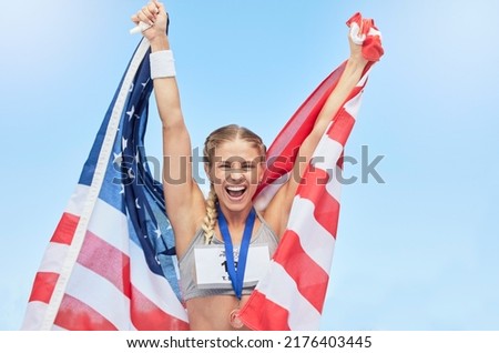 Female american winning athlete cheering and raising USA national flag after competing in sport. Smiling fit active sporty woman feeling motivated and excited, achieving a gold medal in Olympic sport Foto stock © 