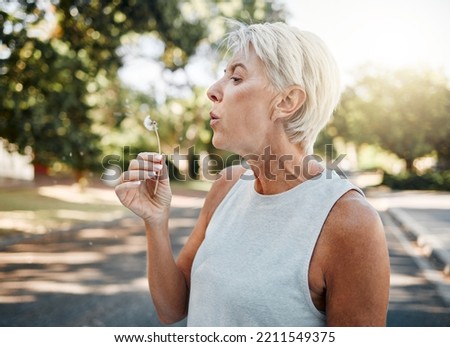 Similar – Image, Stock Photo Woman blowing dandelion in forest during picnic