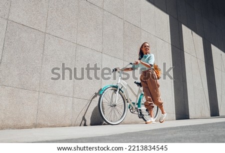 Similar – Image, Stock Photo Ethnic woman with bicycle on street