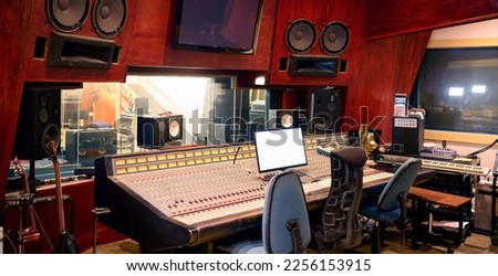 Music, studio and technology with recording equipment in an empty room for the entertainment industry. Interior, creative and audio with musical electronics to produce, record or control sound 商業照片 © 