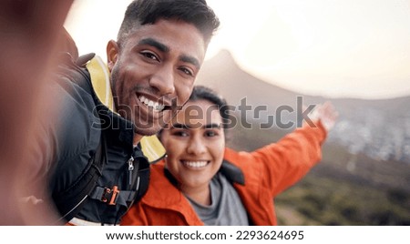 Similar – Image, Stock Photo Young couple taking a selfie while kissing in the mountains