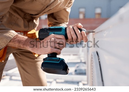 Hands, drill and outdoor with man for air conditioning maintenance, roof or building in city for construction. AC repair, hvac tech or tools for engineer, technician or expert in industry on rooftop Stock photo © 