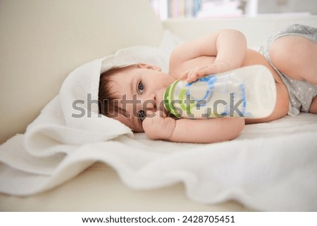 Similar – Image, Stock Photo Newborn drinking milk from a baby bottle, sitting on mom legs outdoors