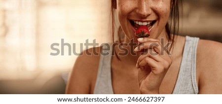 Image, Stock Photo Young woman eating strawberry dessert in cafe