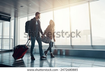 Similar – Image, Stock Photo Female traveler transporting luggage in airport.