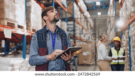 Similar – Image, Stock Photo Male warehouse employee in uniform standing near rack in warehouse