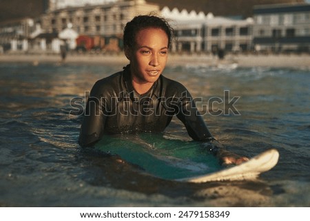 Similar – Image, Stock Photo Surfer woman with wetsuit and surfboard looking at the sea
