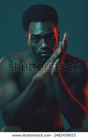 Similar – Image, Stock Photo Serious shirtless black man with makeup and flowers