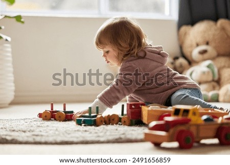 Similar – Image, Stock Photo Baby playing alone with toys on a carpet on the floor at home