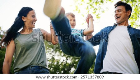 Similar – Image, Stock Photo Father and mother swinging their baby sitting on the green grass in the park. Infant is laughing happy.