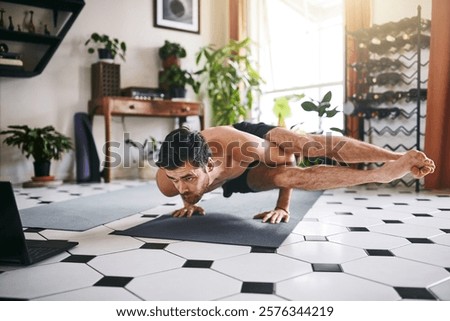 Similar – Image, Stock Photo Strong man performing handstand on sports ground