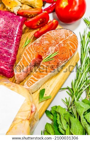 Fresh red fish with rosemary and pepper on a wooden board. Salmon fillet for cooking. Trout with tomans and vegetables Imagine de stoc © 