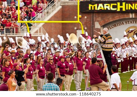 TALLAHASSEE, FL - OCT. 27:  Dr. Clifford Madsen, distinguished Professor of Music at FSU, leads the Marching Chiefs Alumni to sing the Hymn during Homecoming at Doak Campbell Stadium on Oct. 27, 2012.