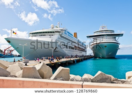 PHILIPSBURG, ST. MAARTEN - JAN.16: Cruise ships docked on the Dutch side of St. Maarten on Jan. 16, 2013.  Philipsburg is one of the busiest islands as the port can accommodate half dozen ships.