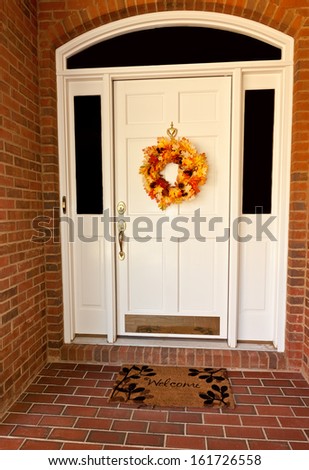 Decorative autumn wreath on a white front door