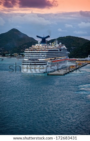 PHILIPSBURG, ST. MAARTEN - JAN. 16, 2013:  The Carnival Dream, Carnival Cruise Line\'s largest ship, departs from the Caribbean island of St. Maarten, a popular travel destination.
