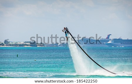 GRAND CAYMAN, CAYMAN ISLANDS - MAR. 8, 2013:  An unidentified man demonstrates the water jet pack at Seven Mile Beach, a popular beach destination on the island for tourists.