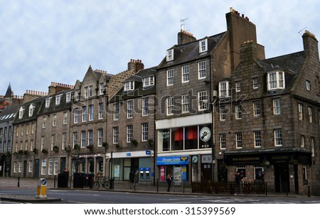 ABERDEEN, SCOTLAND - SEPTEMBER 2015:  Granite townhouses stand on the south side of the Castlegate. The city council has proposed transforming the Castlegate into a civic square.