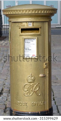 ABERDEEN, SCOTLAND - SEPTEMBER 2015: Postbox painted gold by Royal Mail to commemorate Katherine Grainger's gold medal in the Women's double sculls in the London Olympics, 2012.