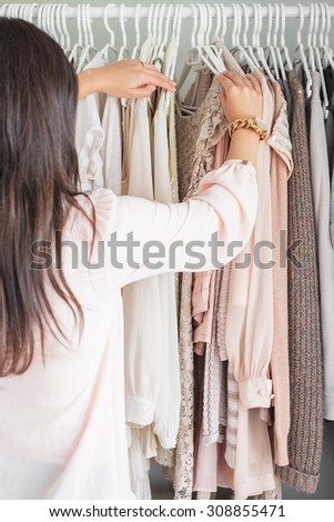 Woman in front of her closet wondering what to choose