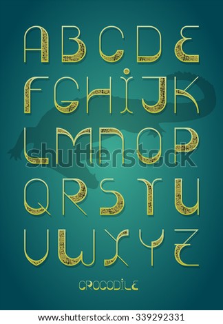 Decorative font with wide elements and strokes. Fashion font. Alphabet. One of color versions with blue background and crocodile silhouette Stok fotoğraf © 