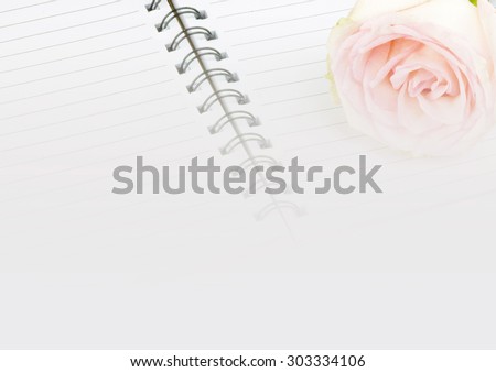 faded notebook paper background with pink rose flower