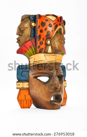 Indian Mayan Aztec wooden painted mask with roaring jaguar and human profiles isolated on white background (left side, ~ 60 degrees)