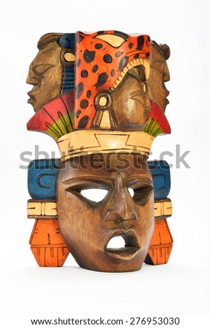 Indian Mayan Aztec wooden painted mask with roaring jaguar and human profiles isolated on white background (left side, ~ 30 degrees)