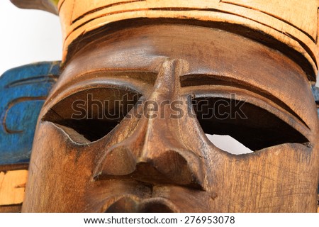 Indian Mayan Aztec wooden painted mask isolated on white background (bottom up diagonal angle, close up)