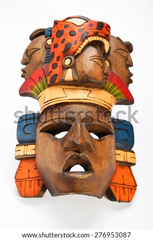 Indian Mayan Aztec wooden painted mask with roaring jaruar and human profiles isolated on white background (below horizon angle take)