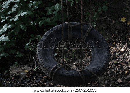 Similar – Image, Stock Photo black chain Tire Swing at a children’s  play ground no people