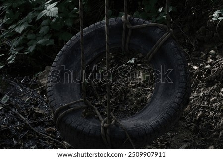 Similar – Image, Stock Photo black chain Tire Swing at a children’s  play ground no people